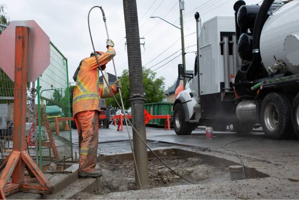 Person-clearing-hole-by-hydro-excavation